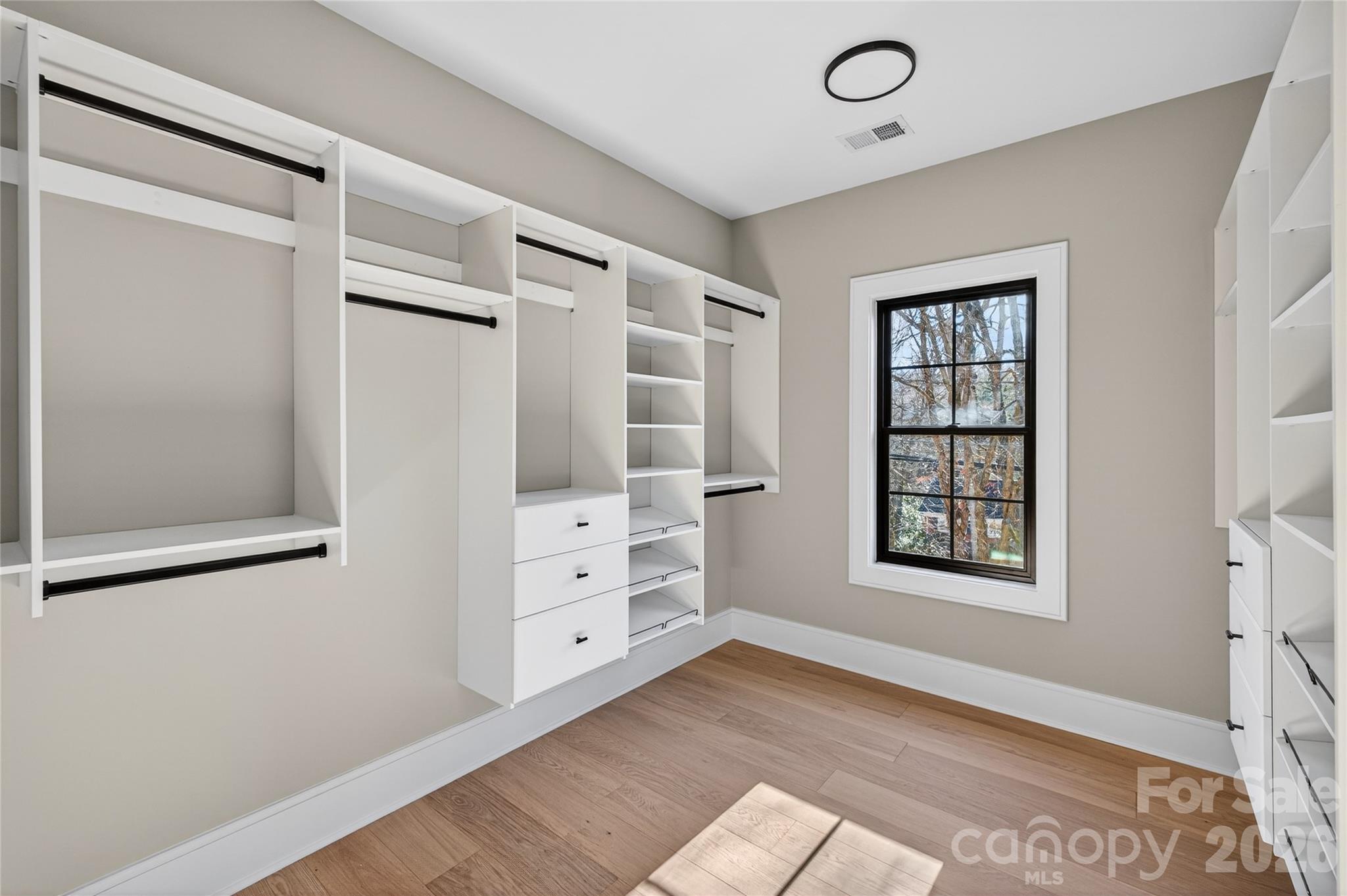 6811 Burlwood Road Charlotte, NC 28211 - Photo 28 of 43 an empty room with windows and cabinet