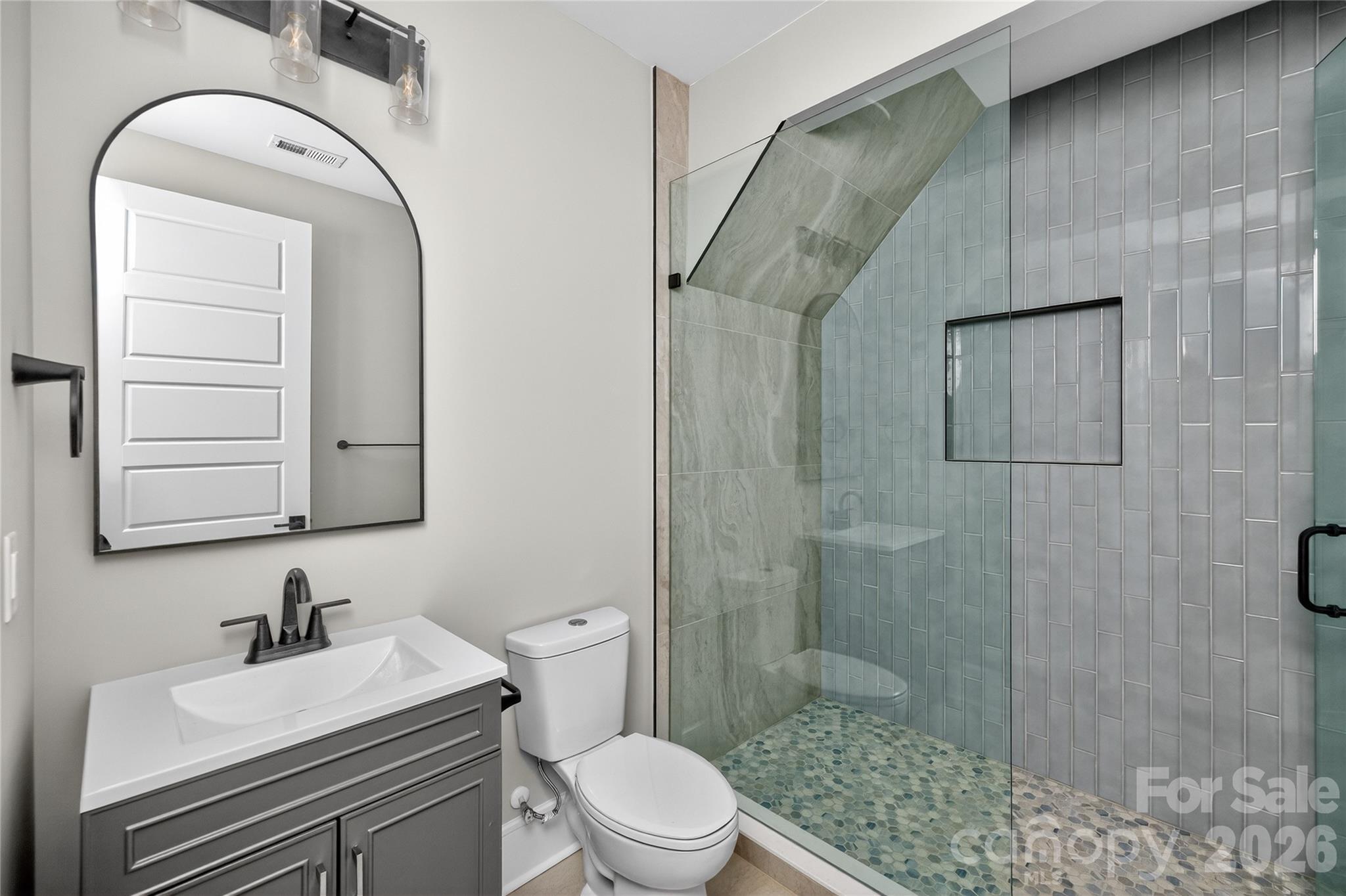 6811 Burlwood Road Charlotte, NC 28211 - Photo 39 of 43 a bathroom with a sink a toilet and shower