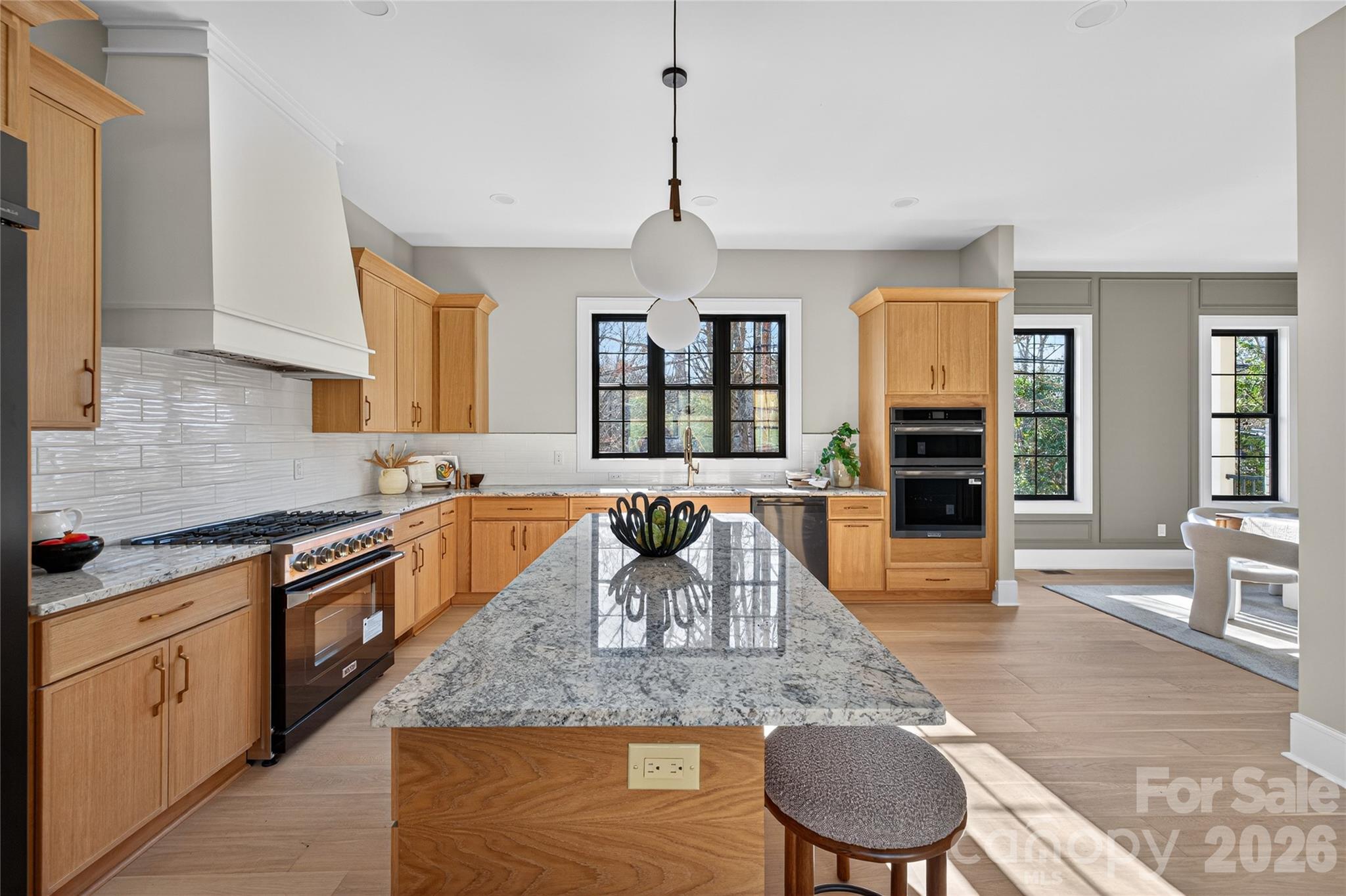 6811 Burlwood Road Charlotte, NC 28211 - Photo 8 of 43 a large kitchen with granite countertop a stove a sink a window and dining table