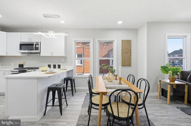 a view of a a dining room with furniture window and wooden floor
