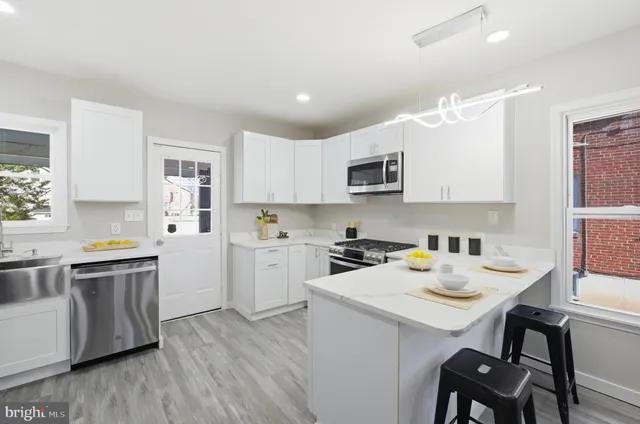 a kitchen with a sink stove top oven and cabinets