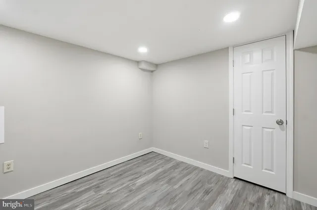 a view of room with wooden floor and window