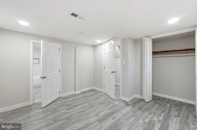 a tree in front of a white house