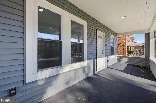 a living room with furniture potted plant and a window