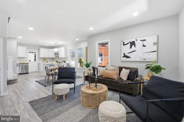 a kitchen with a dining table chairs and refrigerator