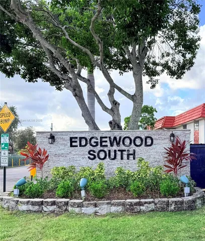 an outdoor space with swimming pool and outdoor seating