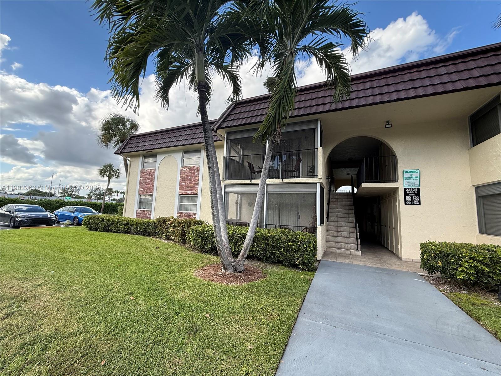 22805 Southwest 66th Avenue, Unit 208 Boca Raton, FL 33428 - Photo 15 of 22 a front view of a house with garden