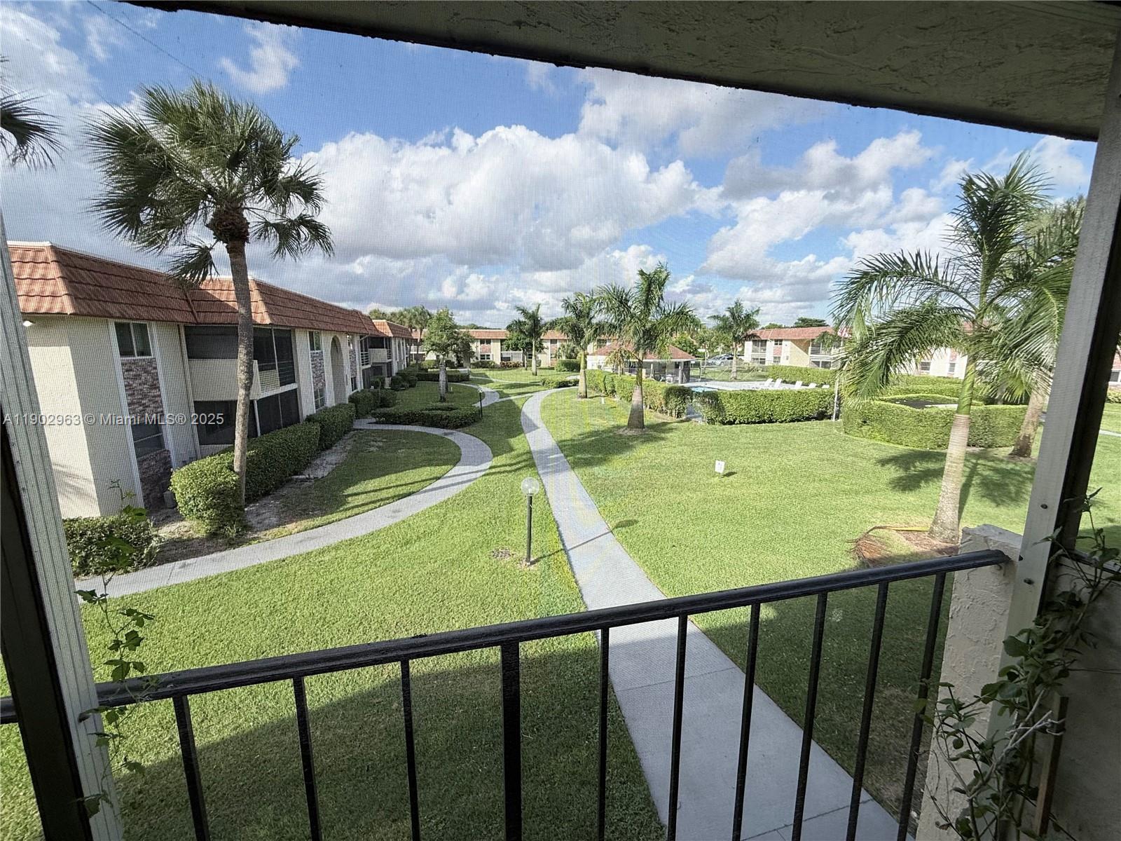 22805 Southwest 66th Avenue, Unit 208 Boca Raton, FL 33428 - Photo 17 of 22 a view of a porch and garden