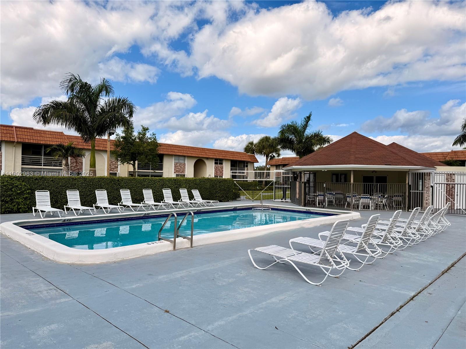 22805 Southwest 66th Avenue, Unit 208 Boca Raton, FL 33428 - Photo 19 of 22 a view of house with outdoor space and swimming pool