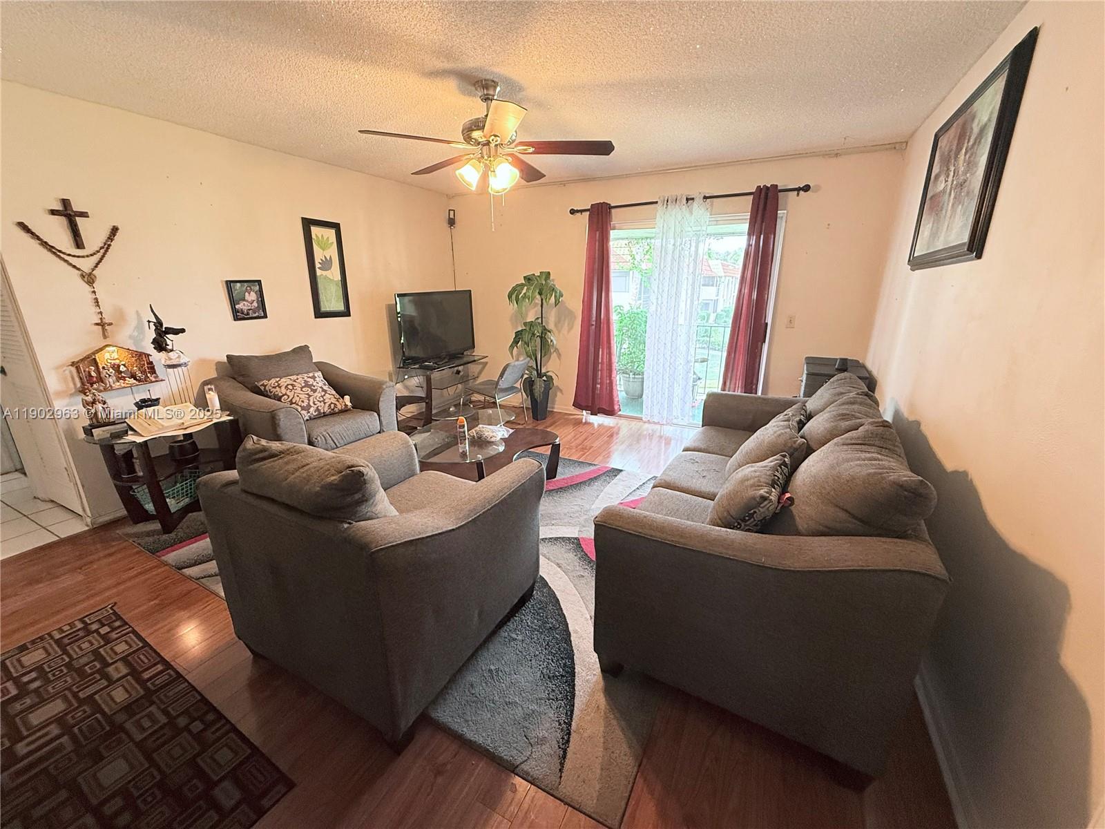 22805 Southwest 66th Avenue, Unit 208 Boca Raton, FL 33428 - Photo 2 of 22 a living room with furniture and a large window