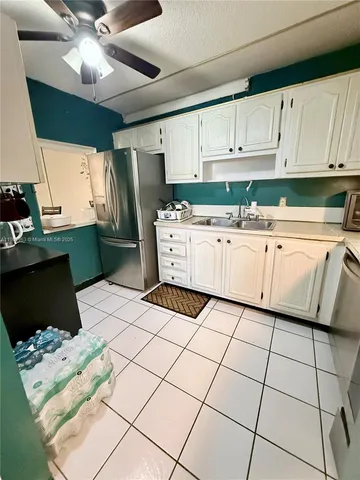a kitchen with cabinets and stainless steel appliances