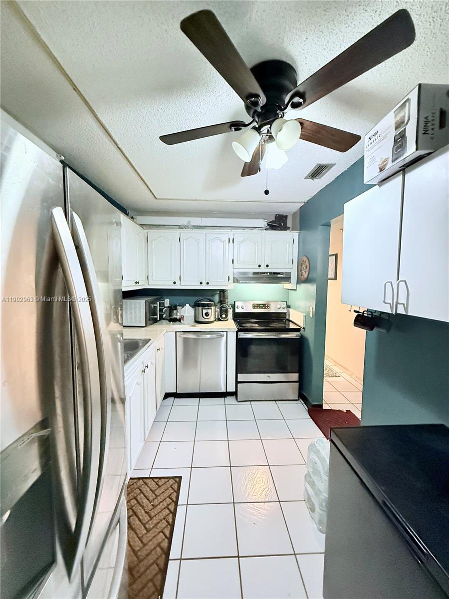 22805 Southwest 66th Avenue, Unit 208 Boca Raton, FL 33428 - Photo 10 of 22 a kitchen with cabinets and stainless steel appliances