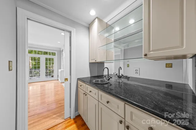 a kitchen with granite countertop a sink and a white stove