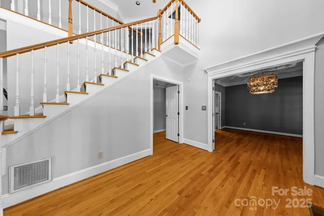 a view of entryway with stairs and wooden floor