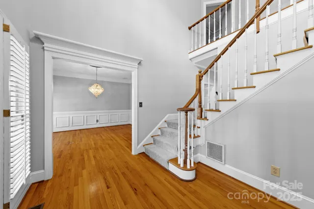 a view of entryway and hall with wooden floor