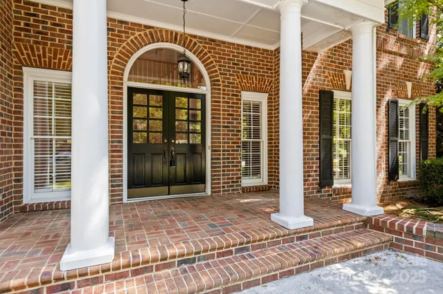 a view of a brick house with large windows