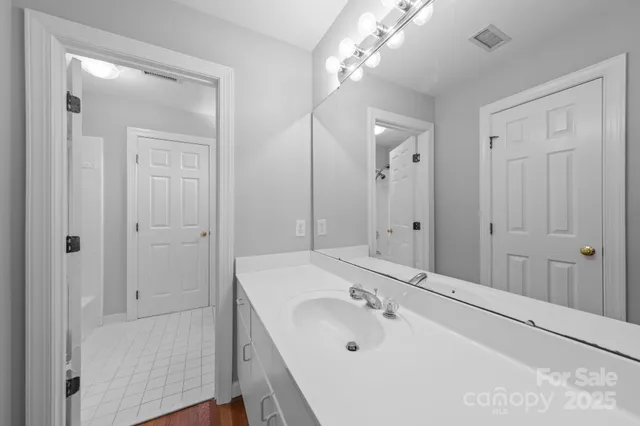 a bathroom with a sink a tub and a mirror