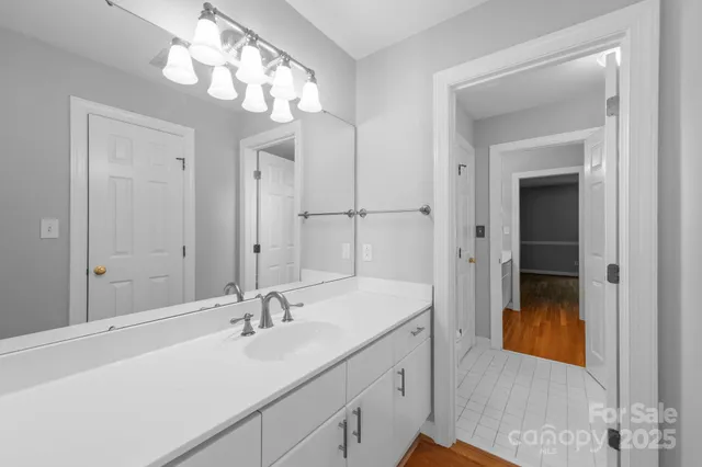 a en suite bathroom with a sink and a mirror