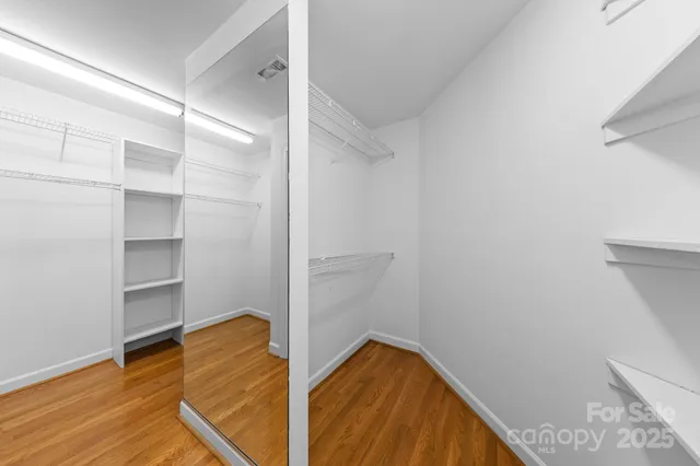 a view of walk in closet with empty racks
