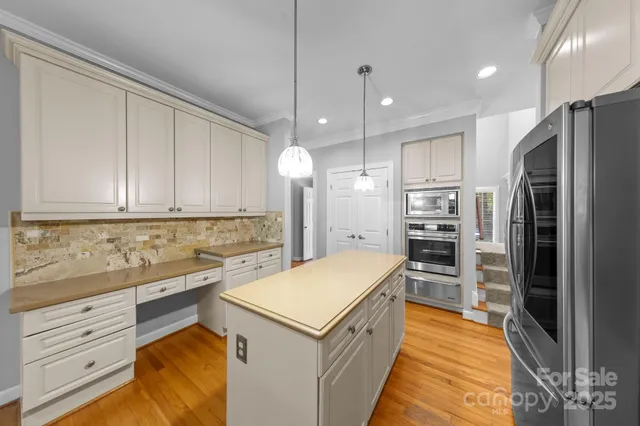 a kitchen with a refrigerator sink and cabinets