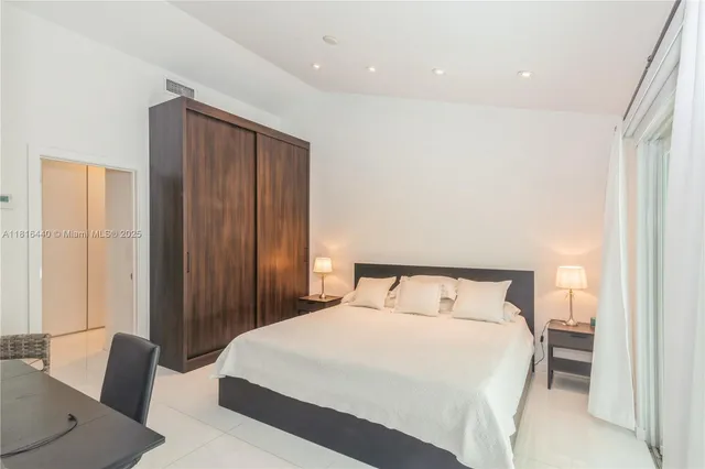 a bedroom with a bed and a chair