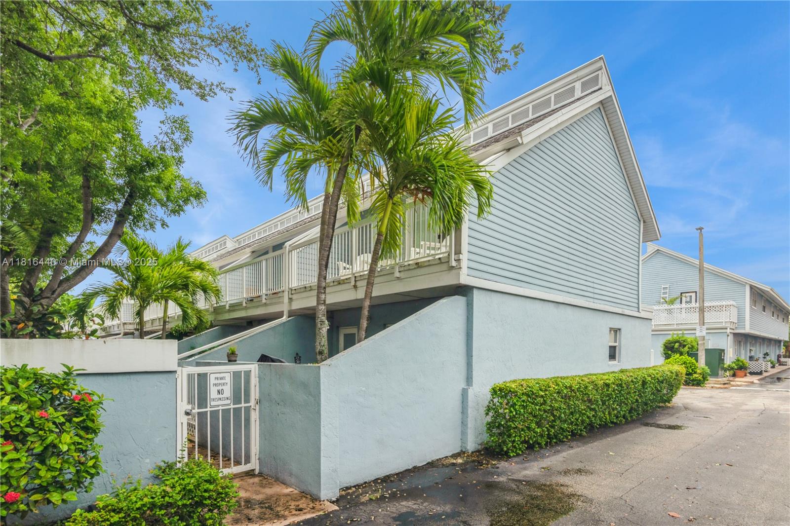 798 Crandon Boulevard, Unit 55B Key Biscayne, FL 33149 - Photo 6 of 8 a house with a tree in front of it