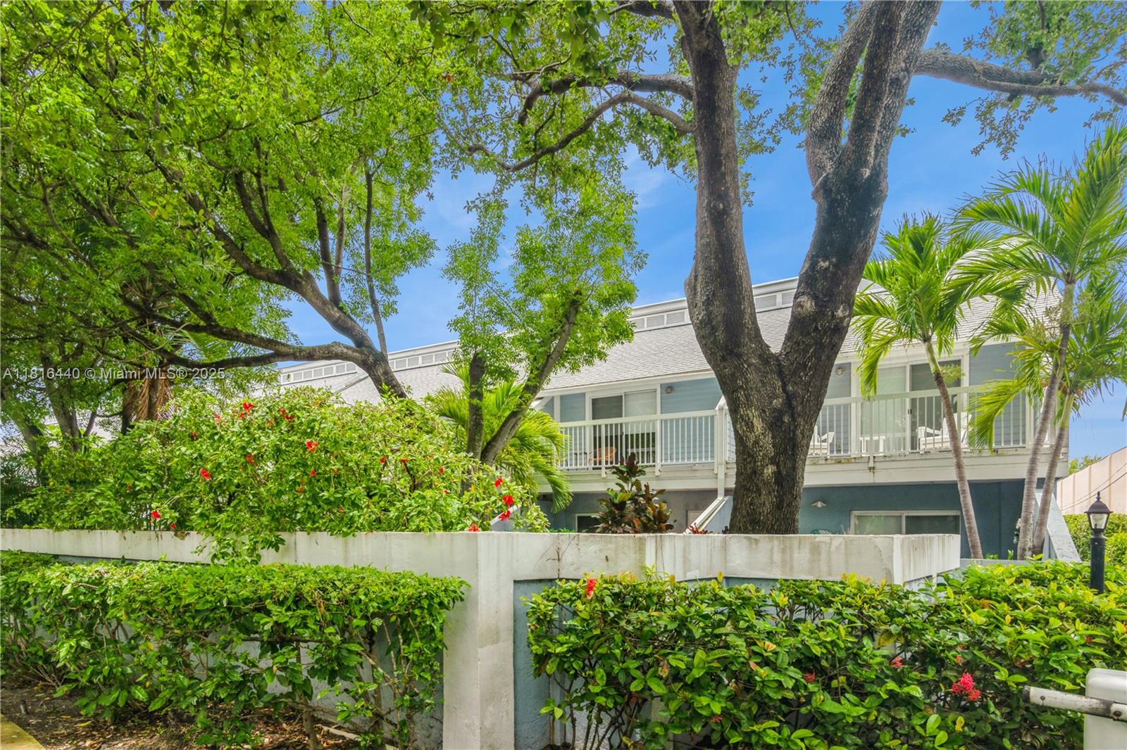 798 Crandon Boulevard, Unit 55B Key Biscayne, FL 33149 - Photo 8 of 8 a front view of a house with a yard