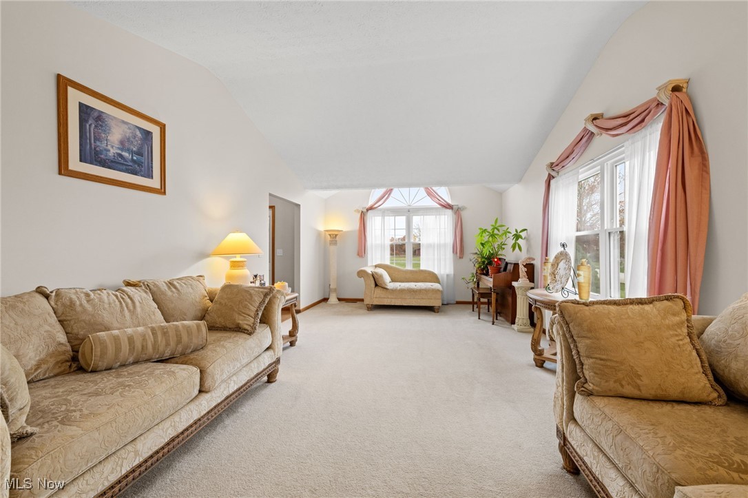 7939 Giddings Road Rootstown, OH 44272 - Photo 6 of 41 Carpeted great room featuring lofted ceiling