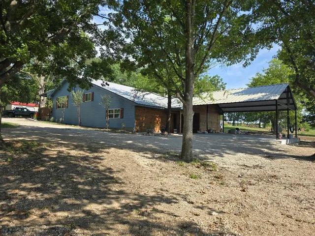a view of a house with a tree