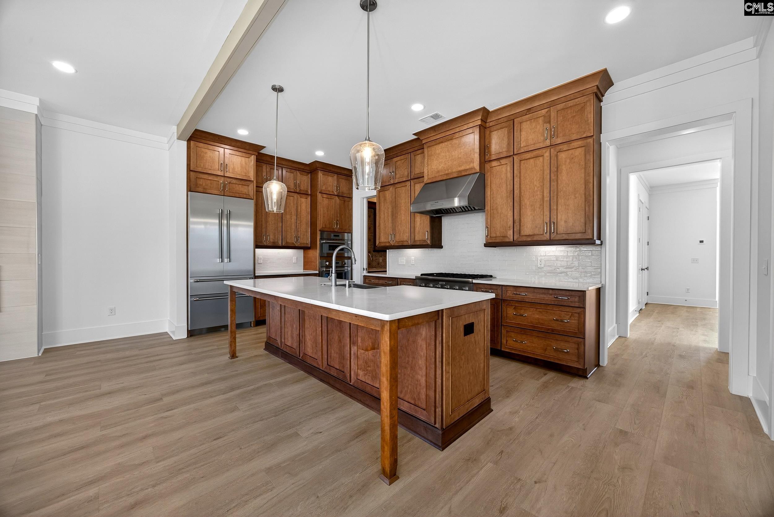 1318 Long Grove Way Lexington, SC 29072 - Photo 6 of 90 a kitchen with stainless steel appliances granite countertop a sink a stove and a wooden floors