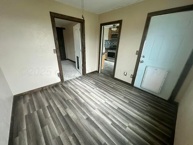 a view of a room with wooden floor and stairs