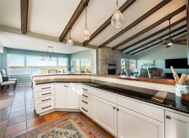 a kitchen with stainless steel appliances granite countertop a sink and cabinets