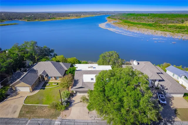 an aerial view of a house with garden space and outdoor seating