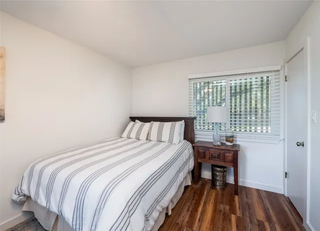 a bedroom with a bed and a table