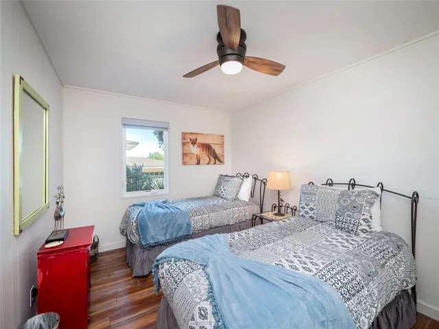 a bedroom with two beds and a chandelier