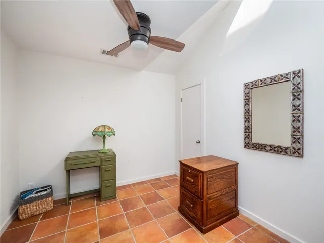 a living room with a couch and a potted plant