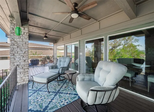 a living room with fireplace furniture and a large window