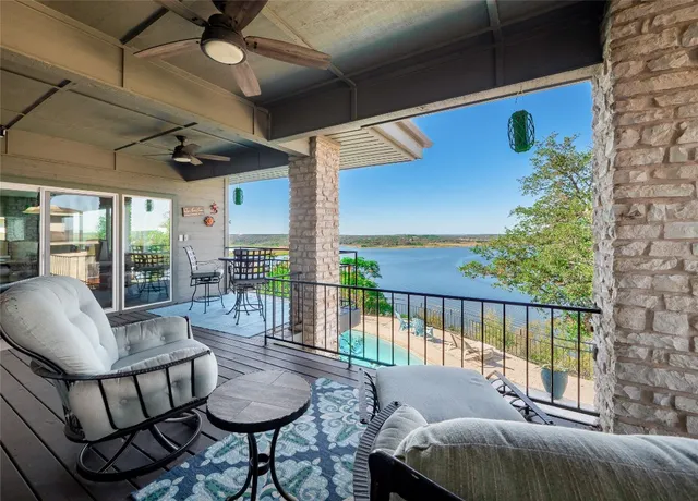 a balcony with furniture and a potted plant