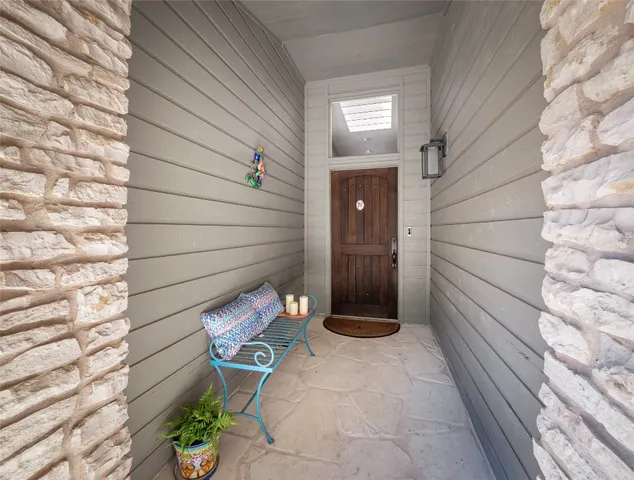 a view of a door and chair front of house