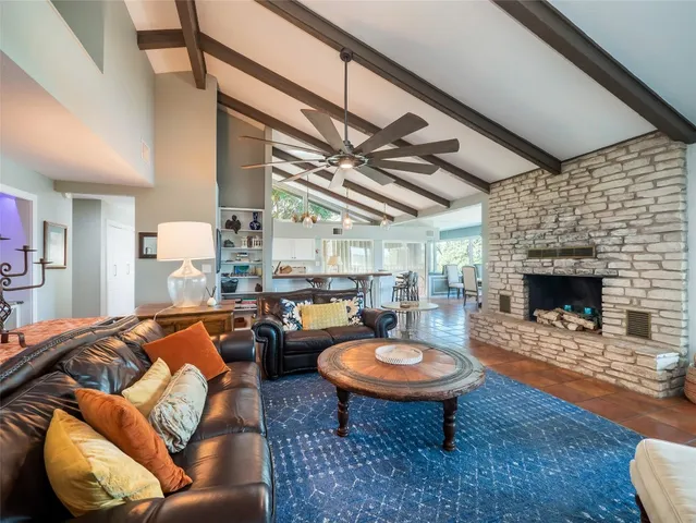 a living room with furniture a fireplace and a table