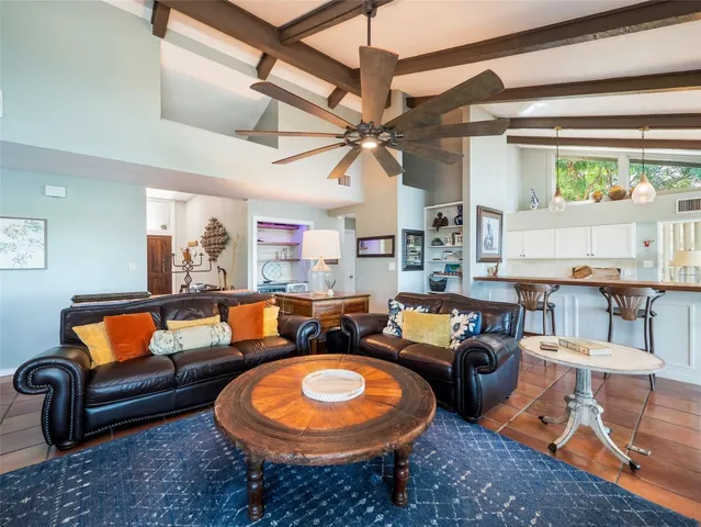 a living room with furniture a rug and a window