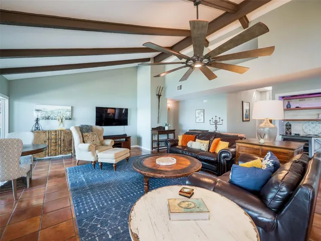 a living room with furniture a rug and a fireplace