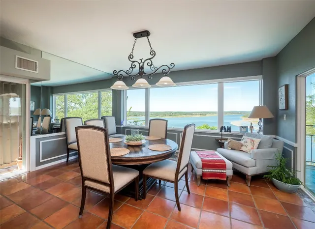 a dining room with furniture a chandelier and wooden floor