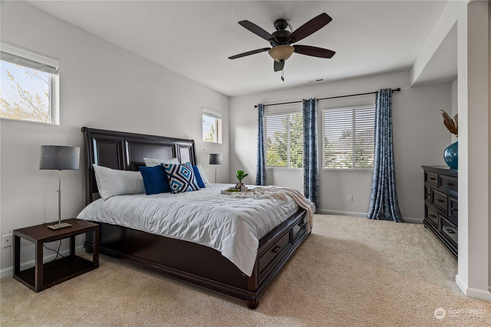 19516 38th Drive Southeast Bothell, WA 98012 - Photo 20 of 34 a spacious bedroom with a large bed and a chandelier