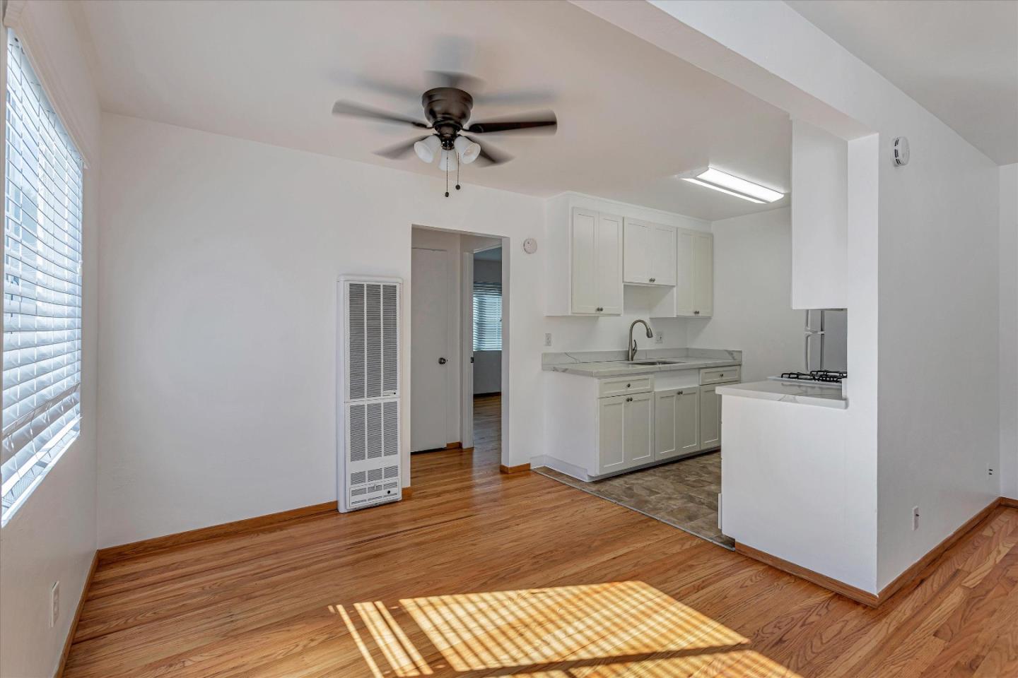 245 Bush Street Mountain View, CA 94041 - Photo 11 of 33 a kitchen with a sink cabinets stainless steel appliances and a window