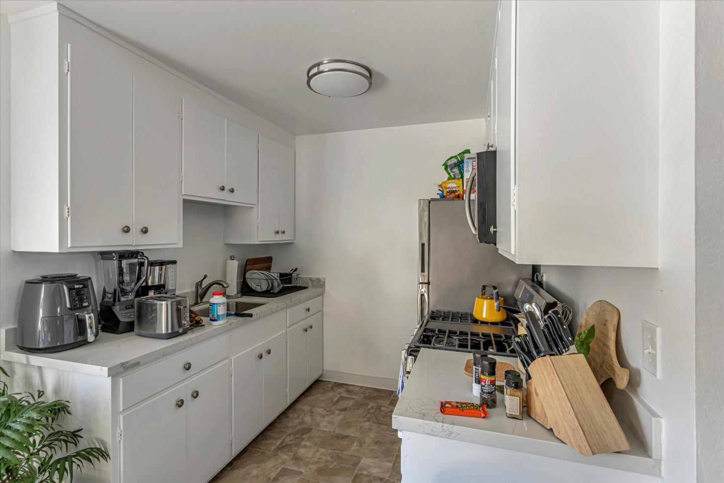 245 Bush Street Mountain View, CA 94041 - Photo 13 of 33 a kitchen with a white stove top oven and cabinets