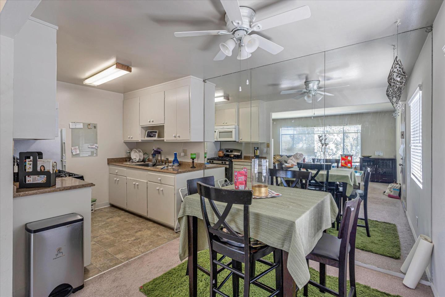 245 Bush Street Mountain View, CA 94041 - Photo 17 of 33 a kitchen with a dining table chairs cabinets and stainless steel appliances