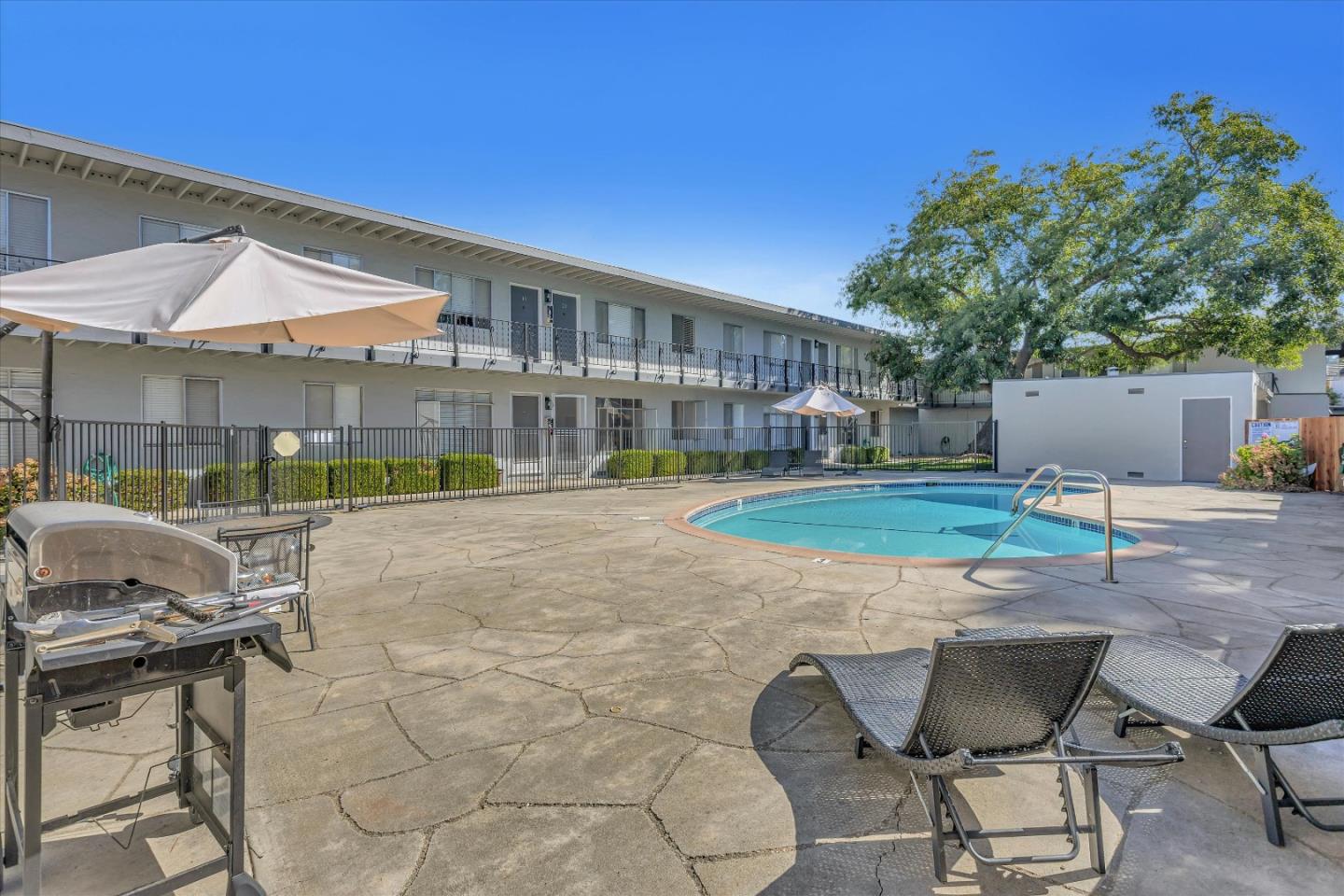245 Bush Street Mountain View, CA 94041 - Photo 6 of 33 a patio with a table and chairs and potted plants