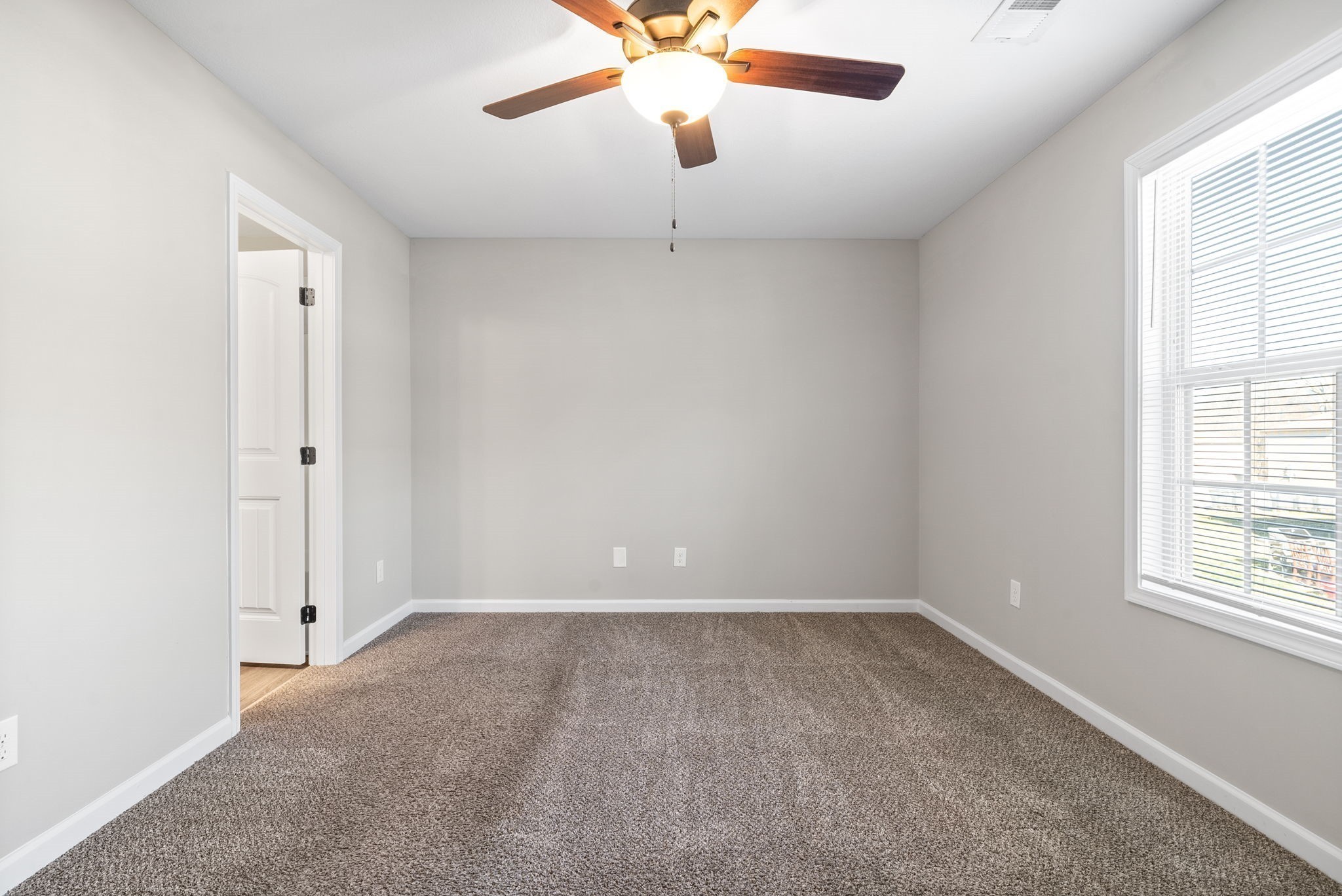 264 Smithson Lane, Unit B Clarksville, TN 37040 - Photo 15 of 25 an empty room with windows and chandelier fan