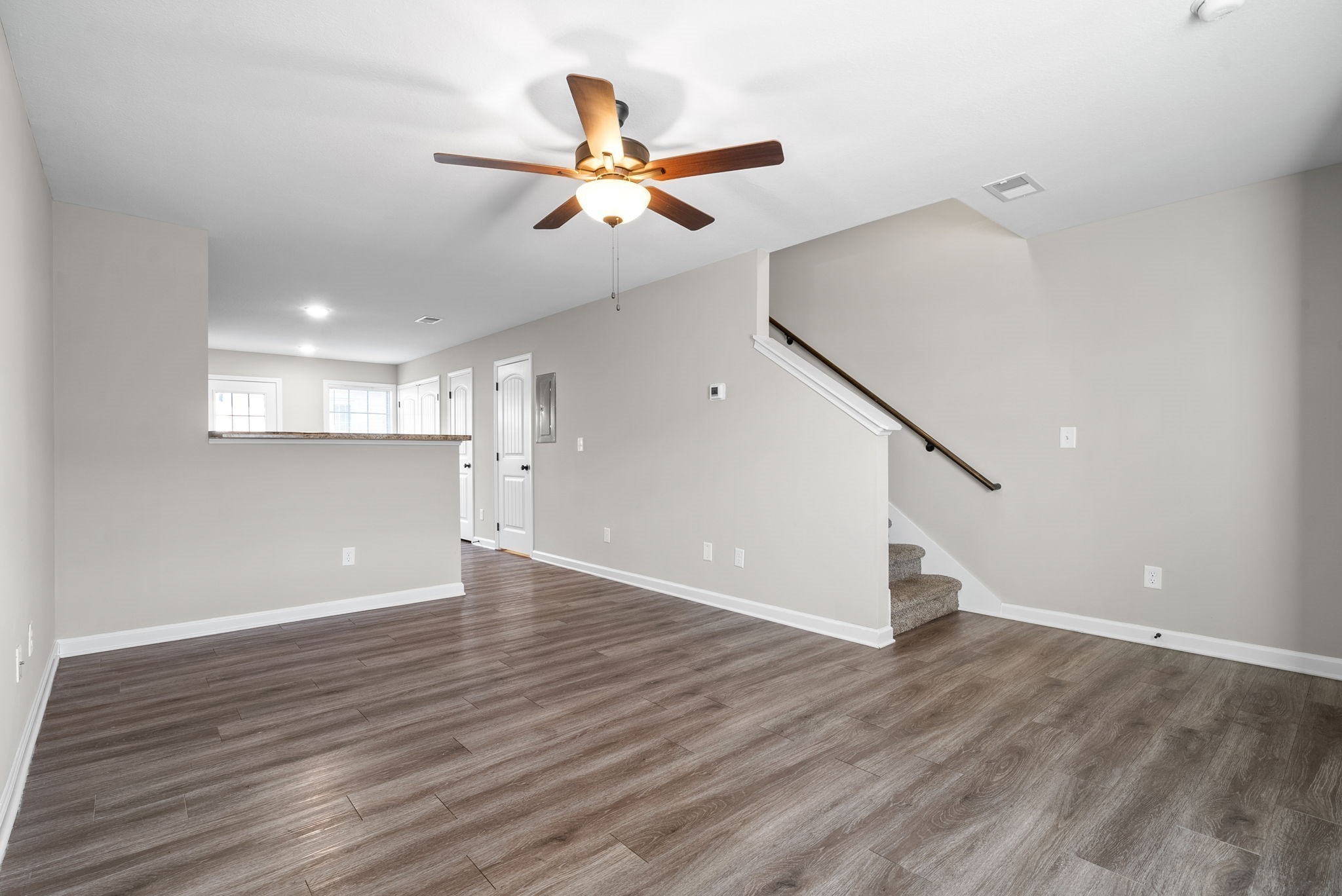 264 Smithson Lane, Unit B Clarksville, TN 37040 - Photo 6 of 25 a view of an empty room with wooden floor and a ceiling fan